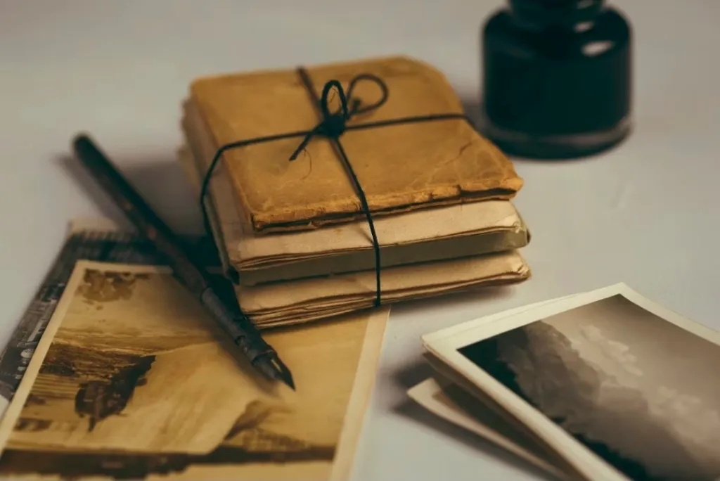 "History, Memory and Archive - image of packet of papers and black and white photographs"