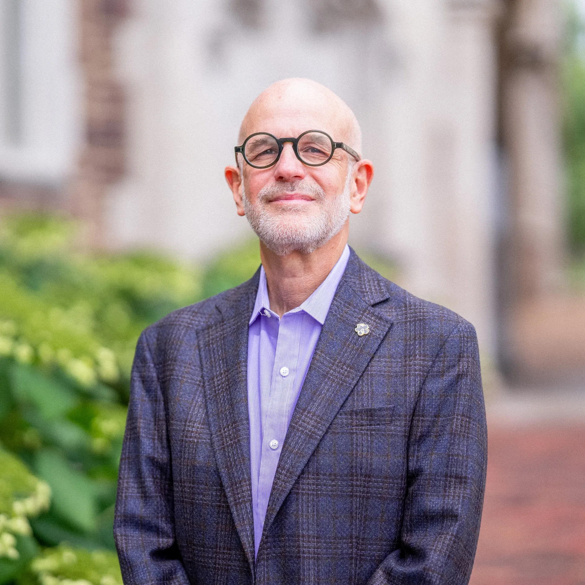Jonathan Judaken, Goldstein Professor of Jewish History and Thought, pictured in a blue suit, smiles at the camera.
