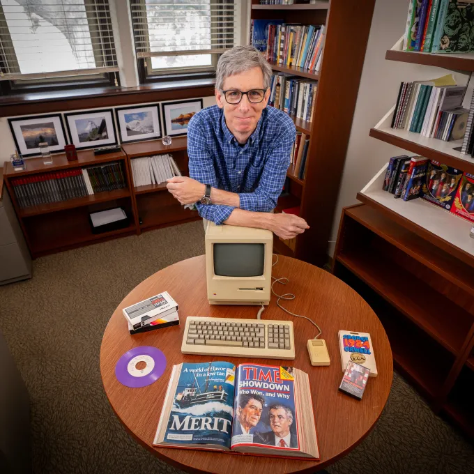 Peter Kastor with objects showcased in his Fall 2024 course "1984: One Weird Year." (Photo: Sean Garcia for WashU)